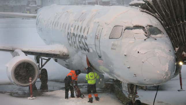 A snow-covered airplane at an American airport 