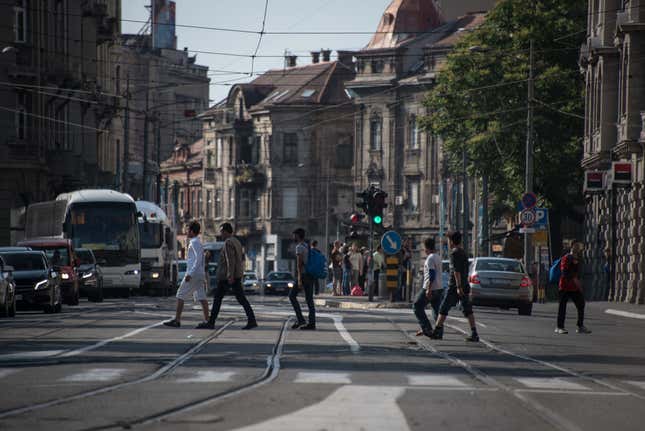 Asylum-seekers cross a street in central Belgrade, a city that has been at the center of smuggling operations in the Balkans and has seen the number of new arrivals increase with the onset of warmer weather.