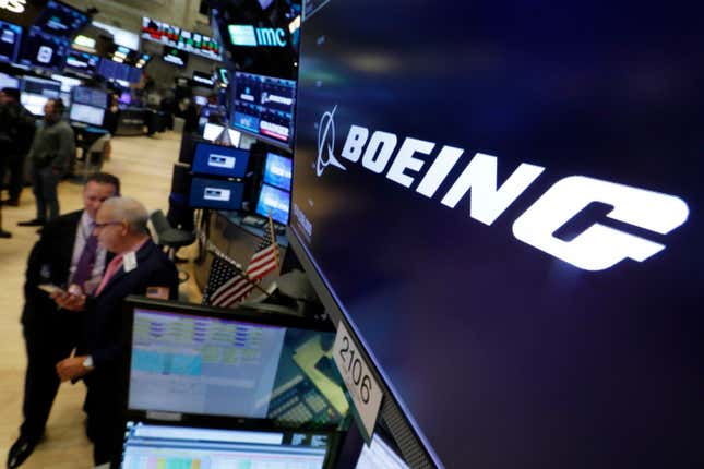 FILE - The logo for Boeing appears above a trading post on the floor of the New York Stock Exchange, Oct. 24, 2018. Boeing CEO David Calhoun received compensation valued at $33 million in 2023, nearly all of it in stock awards, but his stock payout for this year will be cut by nearly one-fourth because of the drop in Boeing’s share price since the January 2024 blowout of a panel on one of its planes in midflight. (AP Photo/Richard Drew, File)