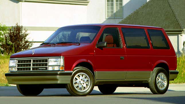 A photo of a red Dodge Caravan minivan from the 1980s. 