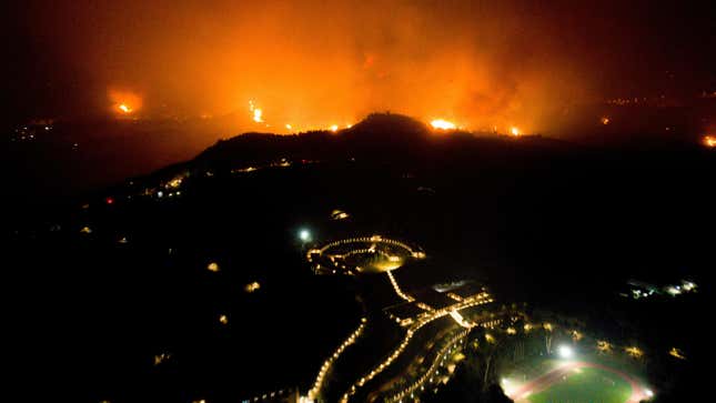 A wildfire approaches the Olympic Academy in western Greece on August 4, 2021.

