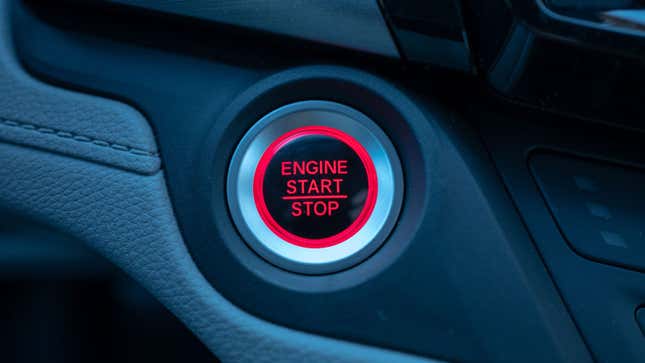 A photo of the engine start button in a car. 