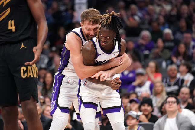 Nov 13, 2023; Sacramento, California, USA; Sacramento Kings forward Domantas Sabonis (10) hugs guard Keon Ellis (23) after Sabonis made a basket while being fouled against the Cleveland Cavaliers in the fourth quarter at the Golden 1 Center.