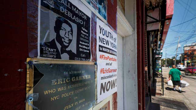 This photo from Tuesday Aug. 20, 2019, shows a memorial plaque for Eric Garner affixed to a building wall below his image, at the site where he died in a police chokehold in Staten Island, N.Y. A state appeals court on Thursday, March 25, 2021 upheld the New York Police Department’s decision to fire the officer for the 2014 chokehold death of Eric Garner.