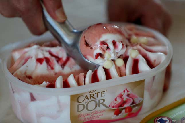 An employee prepares a scoop of ice cream at the Miko Carte d'Or, part of the Unilever group, factory in Saint-Dizier, France, May 4, 2016.