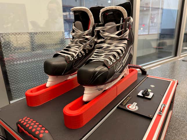 Skates sit in a Conicity Technologies’ grinding machine designed to remove tiny burrs from the metal blades, at the Washington Capitals NHL hockey team practice facility in Arlington, Virginia, Nov. 28, 2023. Dr. Bill Shaffer and son Luke, who come from a metal-cutting background, designed and built the machine they say can dramatically reduce the cutting qualities of skate blades while also keeping them sharp and allowing for better gliding along ice. The death of American hockey player Adam Johnson from a skate cut to the neck during a game in England has led to plenty of talk about how to prevent such injuries in the fast-paced sport, including a new neck laceration protection mandate in the U.S.(AP Photo/Stephen Whyno)