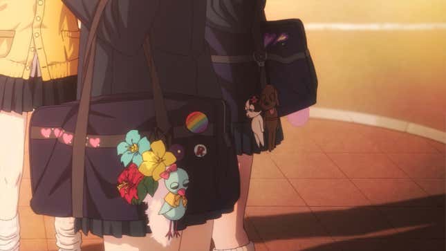 A character's bag is shown with a Pride flag pin on it.