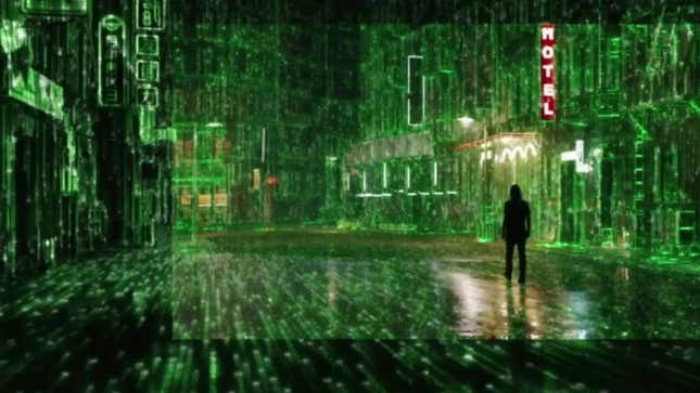 A still from the first Matrix Resurrections trailer is filled with green code overlaying Neo walking an empty street with a hotel sign lit up in red.