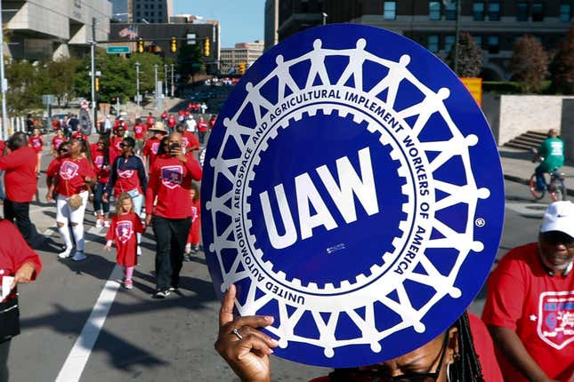 FILE - United Auto Workers members walk in the Labor Day parade, Sept. 2, 2019, in Detroit. The United Auto Workers union announced plans Wednesday, Nov. 29, 2023, to try to simultaneously organize workers at more than a dozen nonunion auto factories. (AP Photo/Paul Sancya, File)