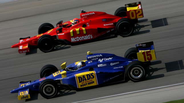 A photo of two Indy Cars racing in 2008. 