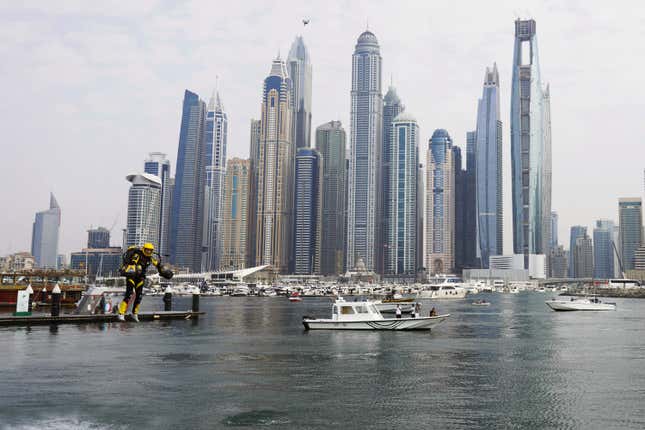 Jet suit pilots race in Dubai, United Arab Emirates, Wednesday, Feb. 28, 2024. Dubai on Wednesday hosted what it called its first-ever jet suit race. Racers zipped along a route with the skyscrapers of Dubai Marina looming behind them, controlling the jet engines on their hands and their backs. (AP Photo/Jon Gambrell)