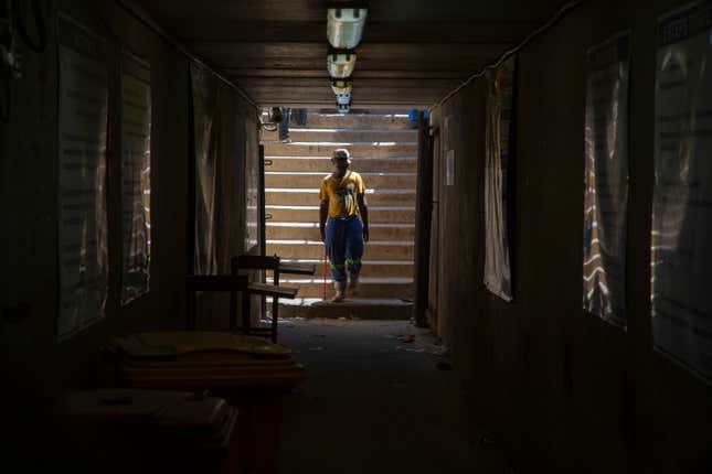 A miner walks at the entrance of a goldmine shaft in Springs, South Africa, Tuesday, Oct. 24, 2023. A group of miners from an unregistered, rival union are holding around 500 of their colleagues underground for the second day at the mine over a union dispute. Some 15 miners have been injured in scuffles, the head of the mine said on Tuesday. (AP Photo/Denis Farrell)