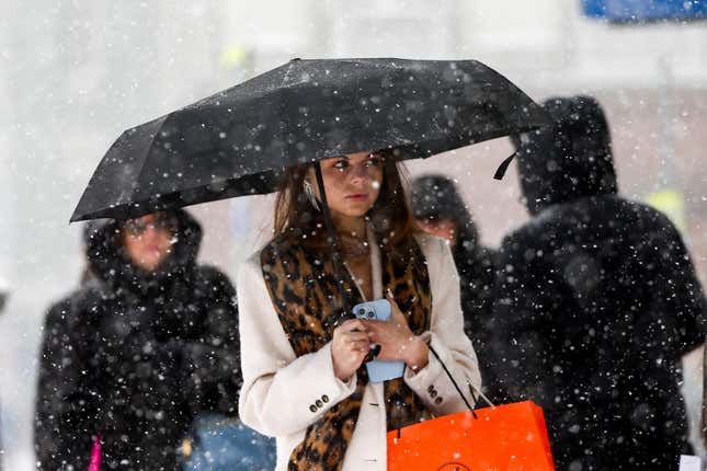 A woman walks down a street during heavy snowfall in Moscow, Russia, Sunday, Dec. 3, 2023. A record snowfall has hit Russia&#39;s capital bringing an additional 10 cm to already high levels of snow and causing disruption at the capital&#39;s airports and on roads. (Sergei Vedyashkin/Moscow News Agency via AP)