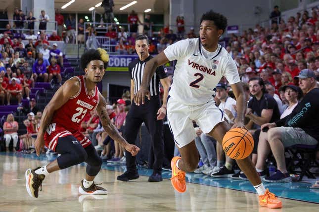 Nov 20, 2023; Fort Myers, Florida, USA;  Virginia Cavaliers guard Reece Beekman (2) moves the ball past Wisconsin Badgers guard Chucky Hepburn (23) in the first half during the Fort Myers Top-Off at Suncoast Credit Union Arena.