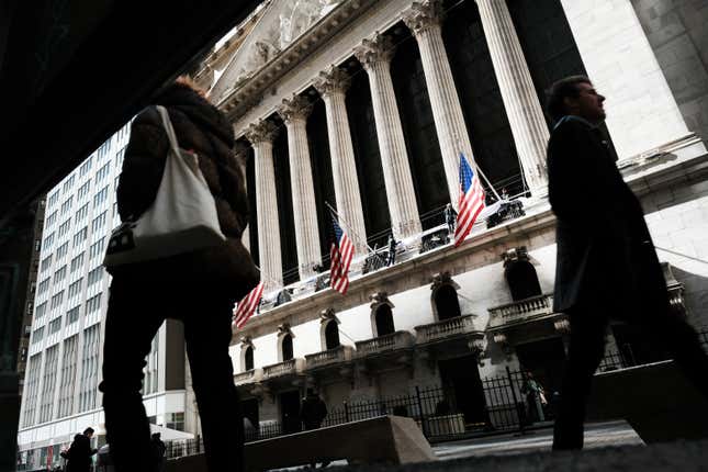 People walk by the New York Stock Exchange.