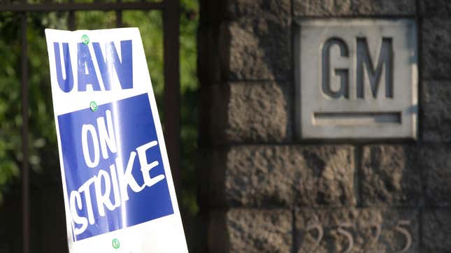  A sign is affixed to a gate as members of the United Auto Workers union protest outside the General Motors Arlington Assembly Plant on September 16, 2019 in Arlington, Texas.