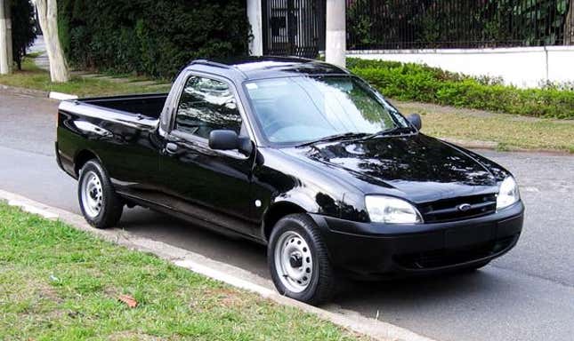 A black Ford Courier parked on a street