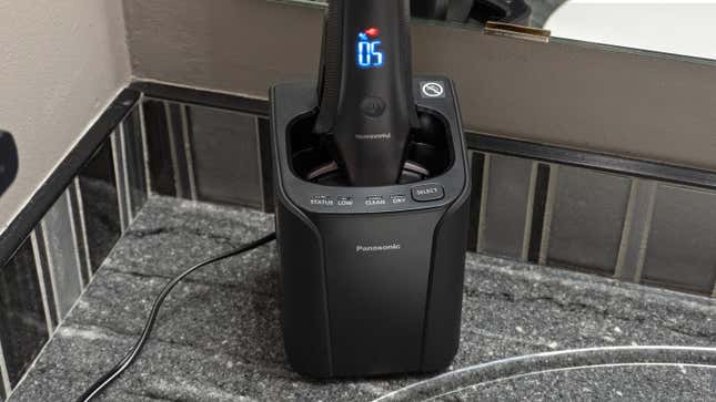 The Panasonic Arc6 razor docked in its cleaning and charging station.