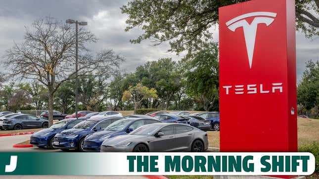 A photo of cars on a lot at a Tesla dealer. 