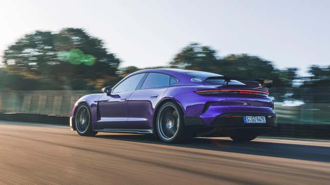 Rear 3/4 view of a purple Porsche Taycan Turbo GT driving on track