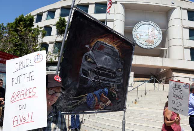 Protesters hold signs during a demonstration outside of the California Public Utilities Commission (CPUC) on August 07, 2023 in San Francisco, California