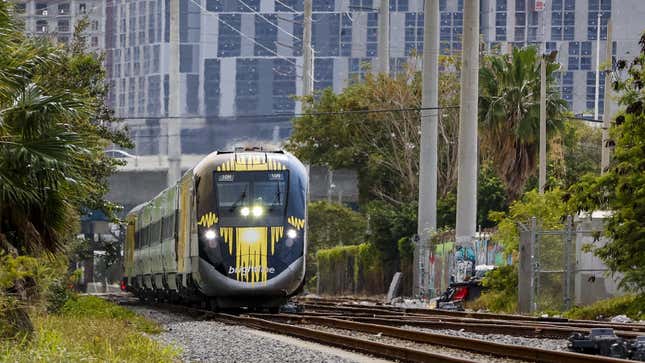 A photo of a Brightline train on the tracks in Florida. 