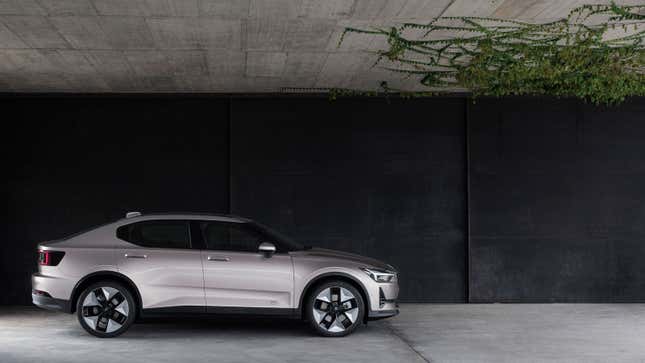 A photo of a golden Polestar 2 electric sedan parked in a garage. 