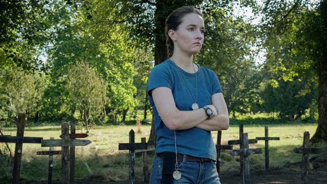 Abby stands in a makeshift graveyard.