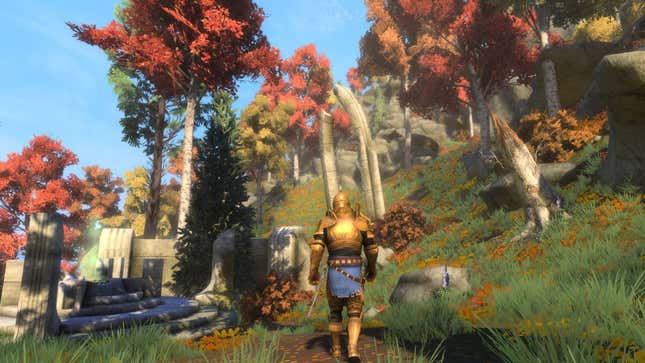 A golden-armored hero walks through the grassland toward some red-leaved trees.