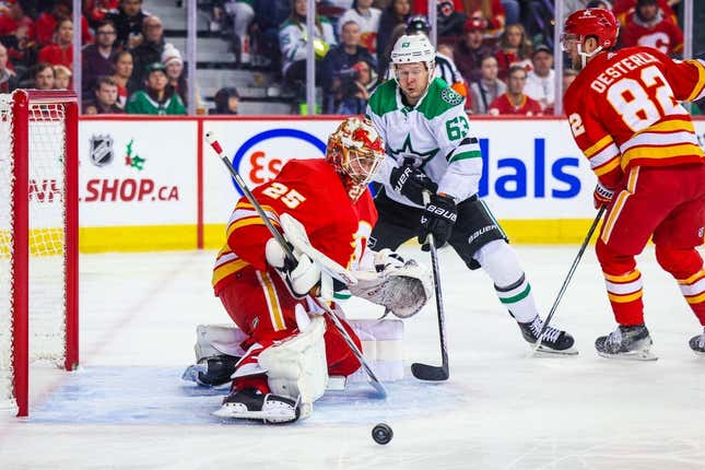 Nov 30, 2023; Calgary, Alberta, CAN; Calgary Flames goaltender Jacob Markstrom (25) makes a save against Dallas Stars right wing Evgenii Dadonov (63) during the first period at Scotiabank Saddledome.