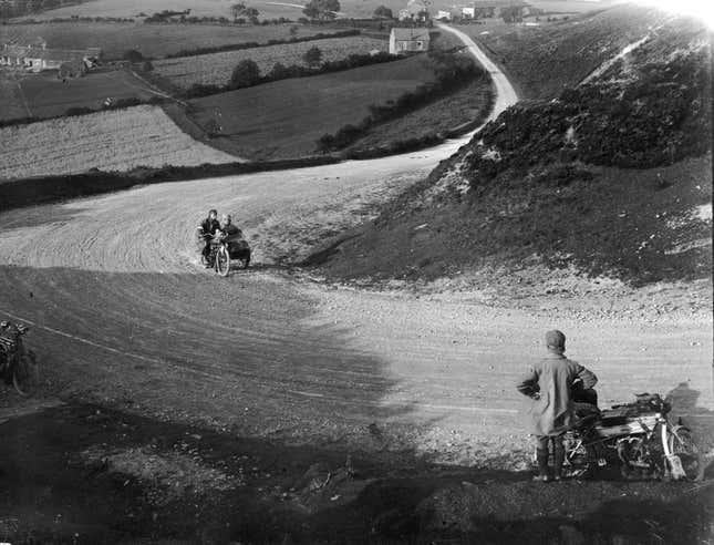 11th August 1911: Motorcyclists with an Indian sidecar climbing up a country road during the 3rd day of the Auto Cycle Union Reliability Trials