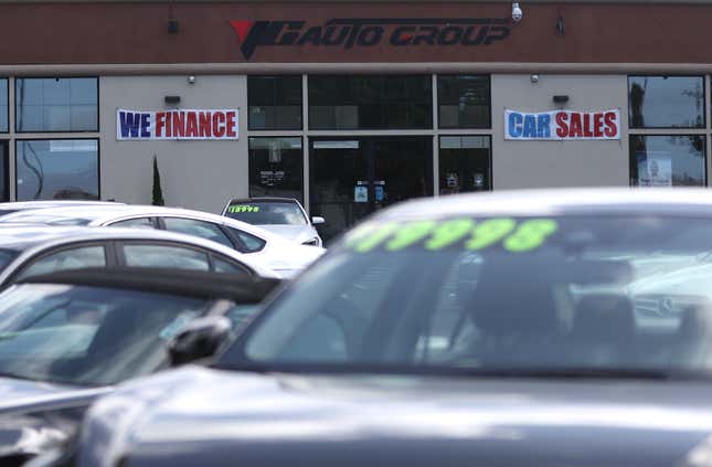 A "We Finance" sign is posted at YG Auto Sales on September 06, 2023 in Richmond, California. Credit monitoring agencies are seeing a rise in defaults of credit card and auto loan payments as inflation continues to squeeze the pocketbooks of many Americans