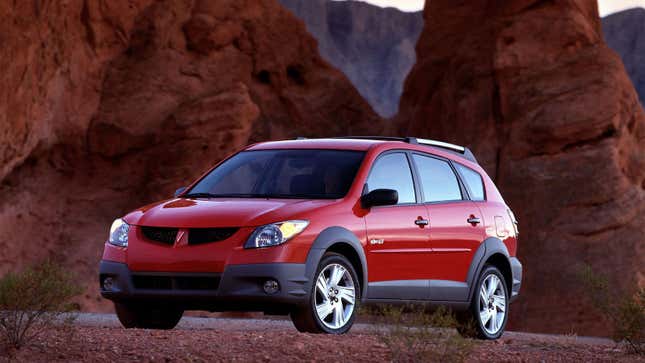 A photo of a red Pontiac Vibe station wagon. 