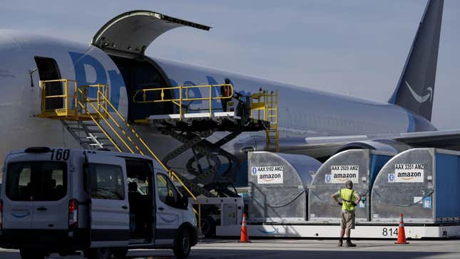 Grounds crew members load cargo into an Amazon Prime Air aircraft at the company's Air Hub at the Cincinnati/Northern Kentucky International Airport (CVG) in Hebron, Kentucky, U.S., on Monday, Oct. 11, 2021.