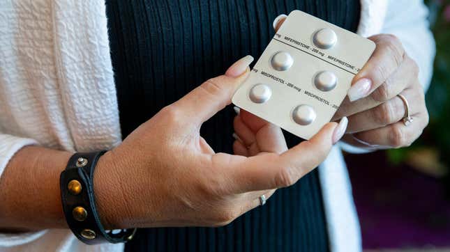 WASHINGTON, D.C. - JULY 1: Melissa Grant, chief operating officer of Carafem, holds up pills used for abortion at the headquarters of Carafem in Washington, D.C., on July 1, 2022. (Amanda Andrade-Rhoades/For The Washington Post via Getty Images)