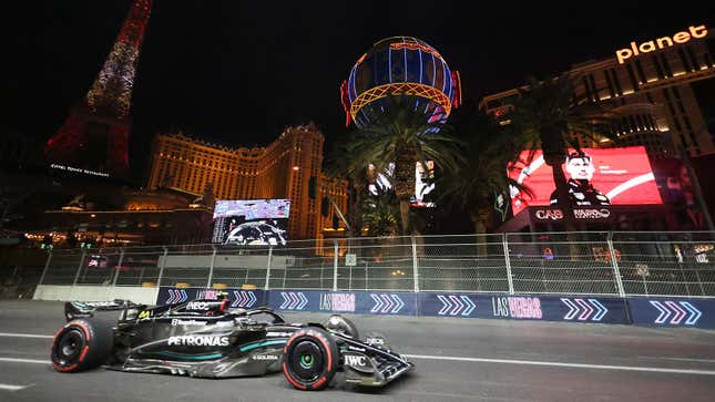 A photo of Lewis Hamilton racing past the Paris hotel and casino. 