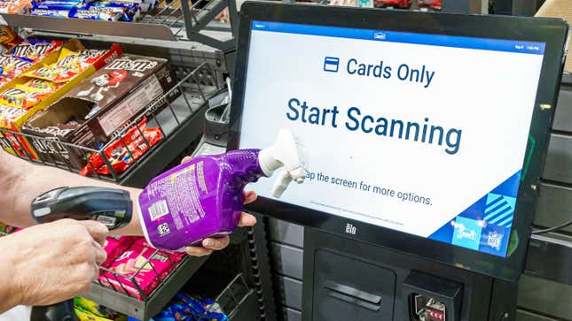 A customer scans an item at a self-service checkout.