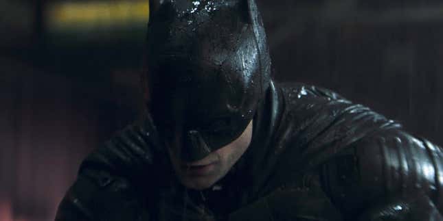 Robert Pattinson in full costume for The Batman, drenched in rain. 