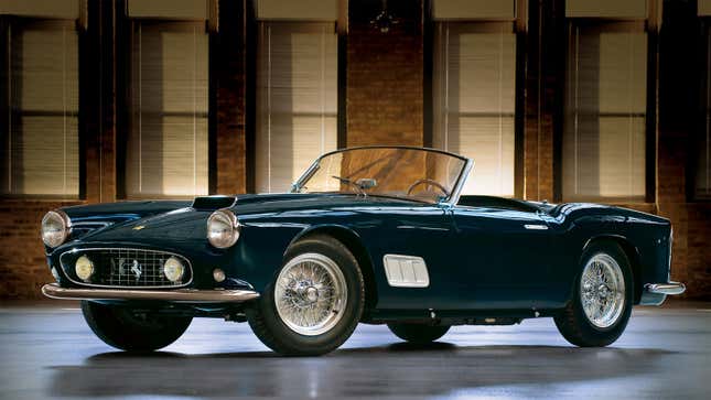 A photo of a dark blue Ferrari California sports car taken in a studio. 