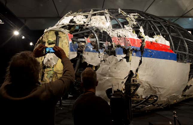 FILE - Journalists take images of part of the reconstructed forward section of the fuselage after the presentation of the Dutch Safety Board&#39;s final report into what caused Malaysia Airlines Flight 17 to break up high over Eastern Ukraine, during a press conference in Gilze-Rijen, Netherlands, Tuesday, Oct. 13, 2015 The Dutch government has spent more than 166 million euros ($180 million) dealing with the aftermath of the downing of Malaysia Airlines flight MH17 over eastern Ukraine in 2014 — from repatriating victims&#39; bodies to investigating and prosecuting some of those involved in the downing, according to an official report Thursday, Feb. 29, 2024. (AP Photo/Peter Dejong, File)