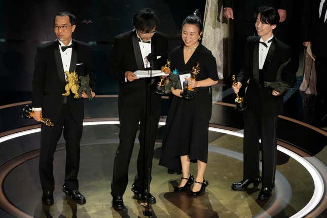 FILE - Masaki Takahashi, from left, Takashi Yamazaki, Kiyoko Shibuya, and Tatsuji Nojima accept the award for best visual effects for &quot;Godzilla Minus One&quot; during the Oscars on March 10, 2024, at the Dolby Theatre in Los Angeles. One Japanese creation grabbing attention on the Oscars red carpet wasn&#39;t a movie: the kitsch shoes that seemed to be clenched in Godzilla&#39;s claw. They were the work of Ryosuke Matsui, who recently described his joy at seeing “Godzilla Minus One” director Takashi Yamazaki and his Shirogumi special-effects team walk the red carpet and win the visual effects Oscar, all while wearing his shoes. (AP Photo/Chris Pizzello, File)