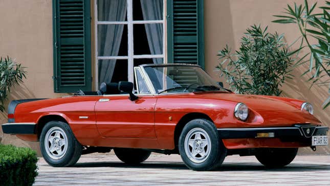 A photo of a red Alfa Romeo Spider from the 1980s.