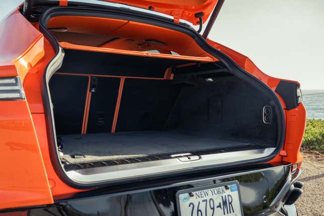 Cargo area of an orange 2025 Aston Martin DBX707