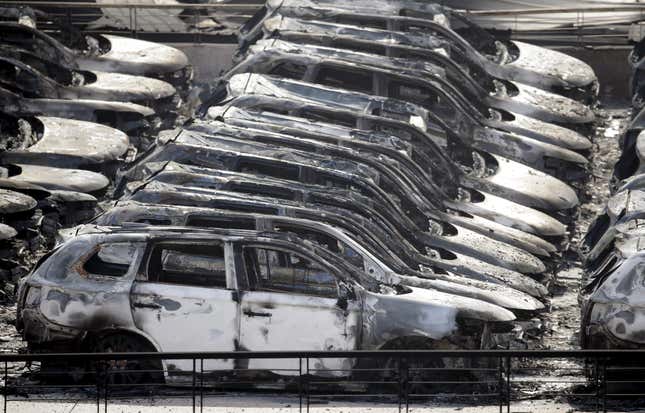 Damaged vehicles near the site of the explosions.