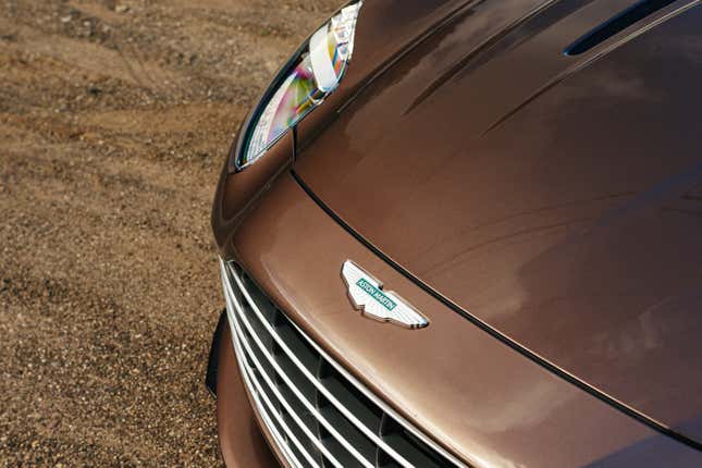 Front badge of a brown Aston Martin DB12 Volante