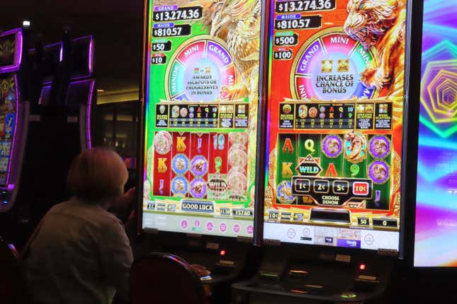 A gambler plays a slot machine at Harrah&#39;s casino in Atlantic City, N.J., on Sept. 29, 2023. On Nov. 21, 2023, New Jersey gambling regulators said Atlantic City&#39;s casinos and two internet-only entities earned $281.2 million in the third quarter of this year, a decline of 7.5% from the same period a year ago. (AP Photo/Wayne Parry)