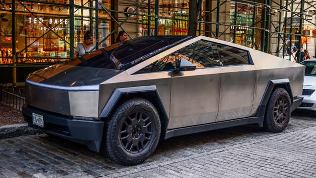 A photo of a Tesla Cybertruck parked on a street. 