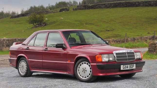 A photo of a red Mercedes-Benz 190E sedan. 