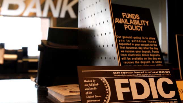 Signs explaining Federal Deposit Insurance Corporation (FDIC) and other banking policies are shown on the counter of a bank in Westminster, Colorado November 3, 2009.