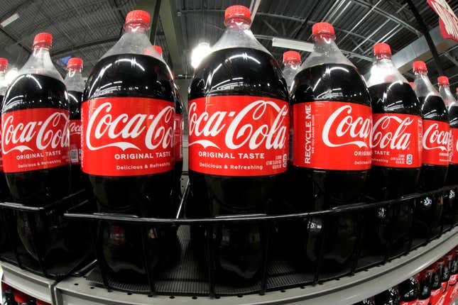 FILE - Bottles of Coca Cola are shown in a market in Pittsburgh on Jan. 26, 2023. Coca Cola reports results on Tuesday, Feb. 13, 2024. (AP Photo/Gene J. Puskar)